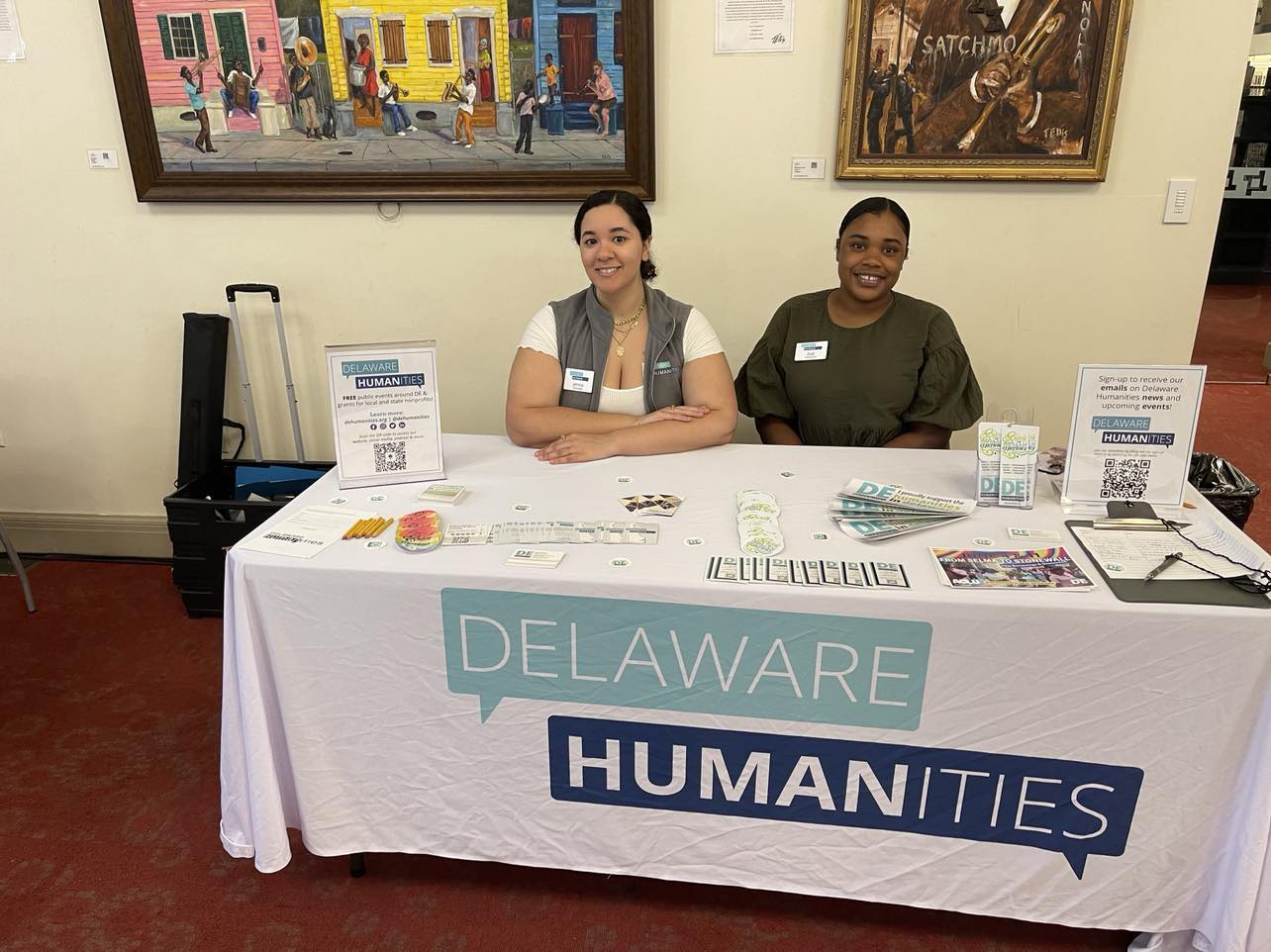 Jenna Greenlee (left) and Zoe Yearwood (right) of Delaware Humanities set up table at "An Evening With Actress Lynn Whitfield" at the Wilmington Public Library. Photo Credit: Mark Tyler