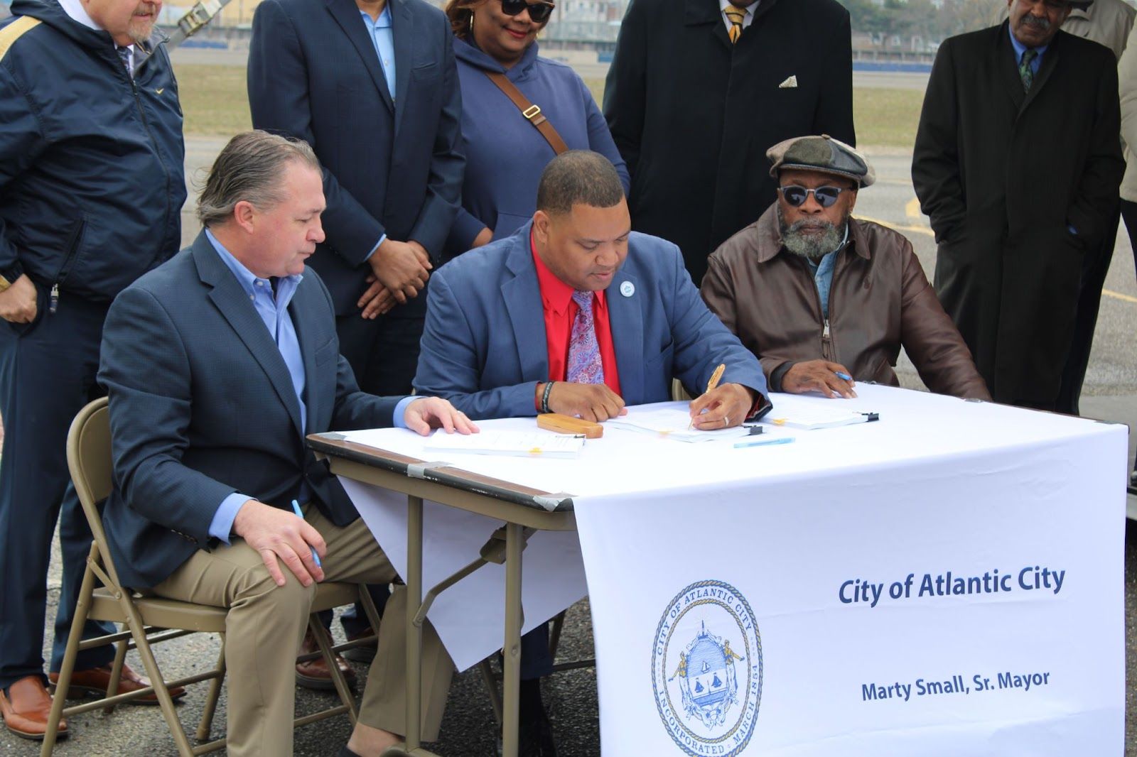 Mayor Marty Small Sr. (Center), Attorney Daniel J. Gallagher (Left) and City Council President Aaron Sporty Randolph (Right) sign MOU with DEEM Enterprises, LLC. Image Source: City of Atlantic City.